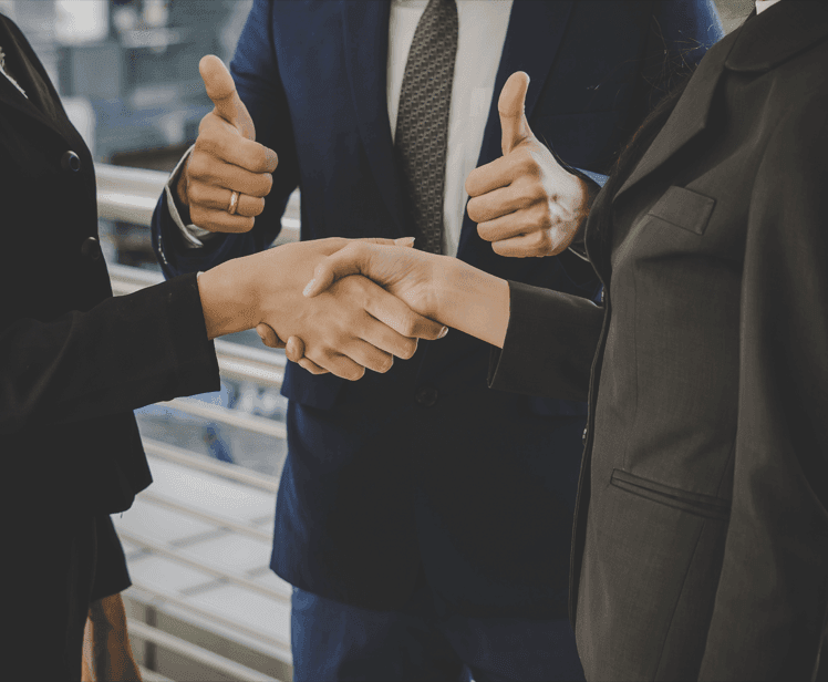 Colleagues shaking hands after resolving a query